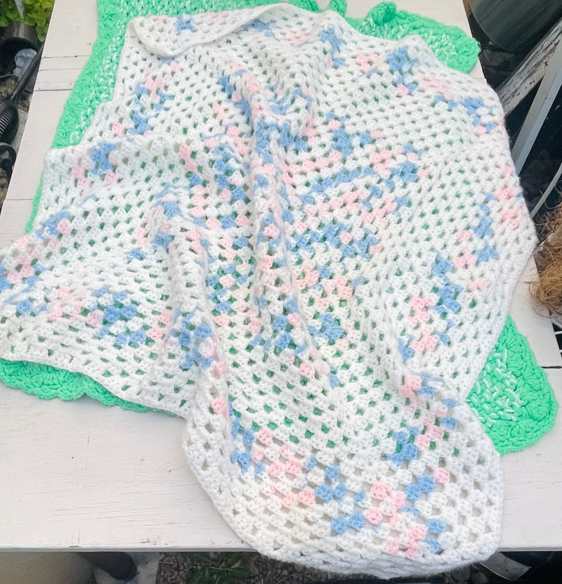 Pink blue and white crocheted baby blanket