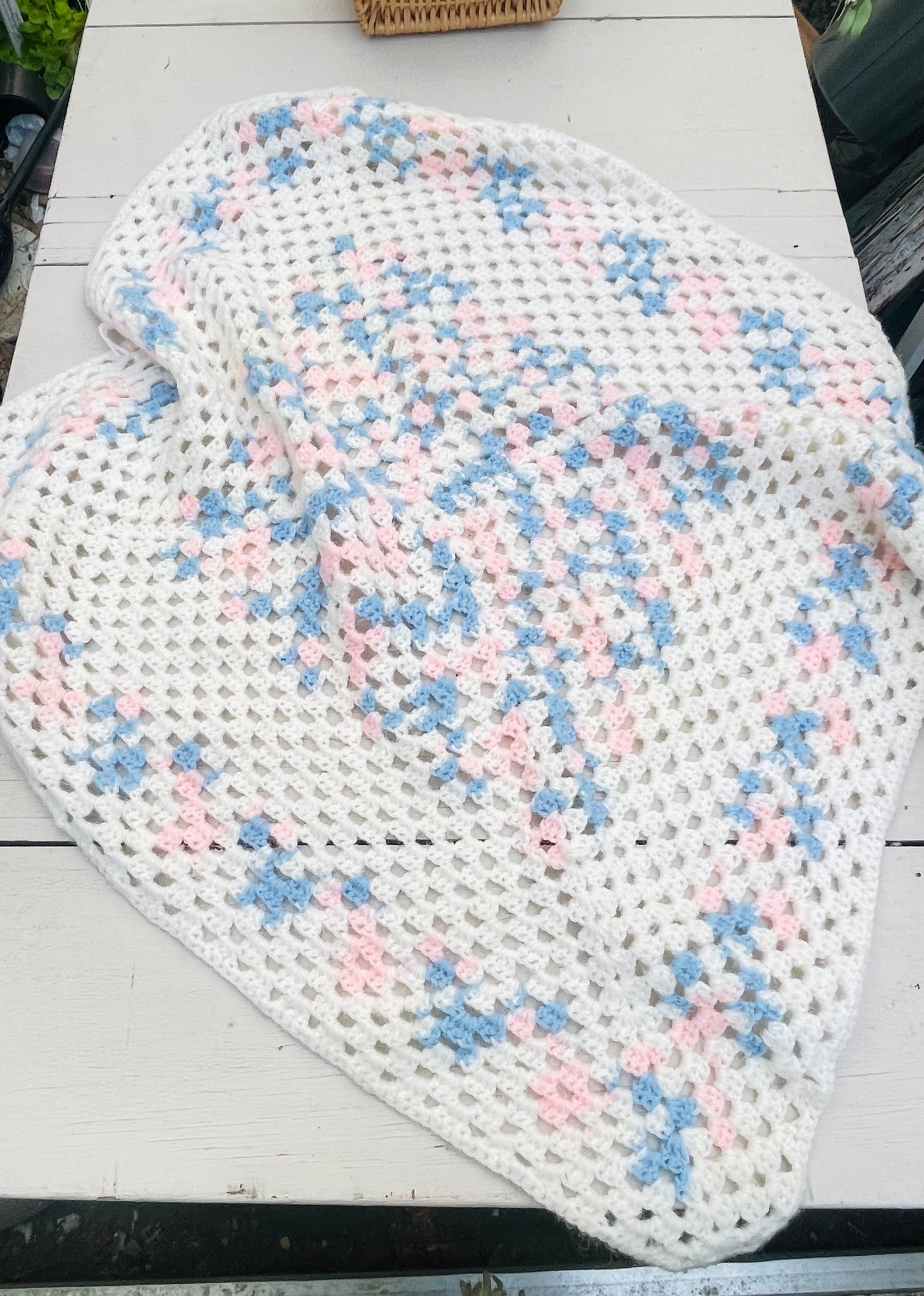 Pink blue and white crocheted baby blanket